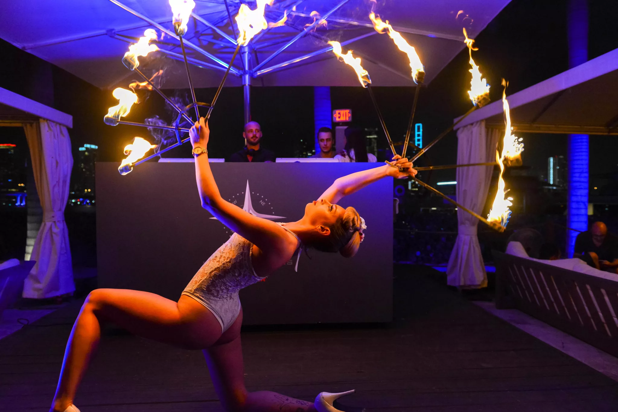 fire juggler in front of dj booth at island garden