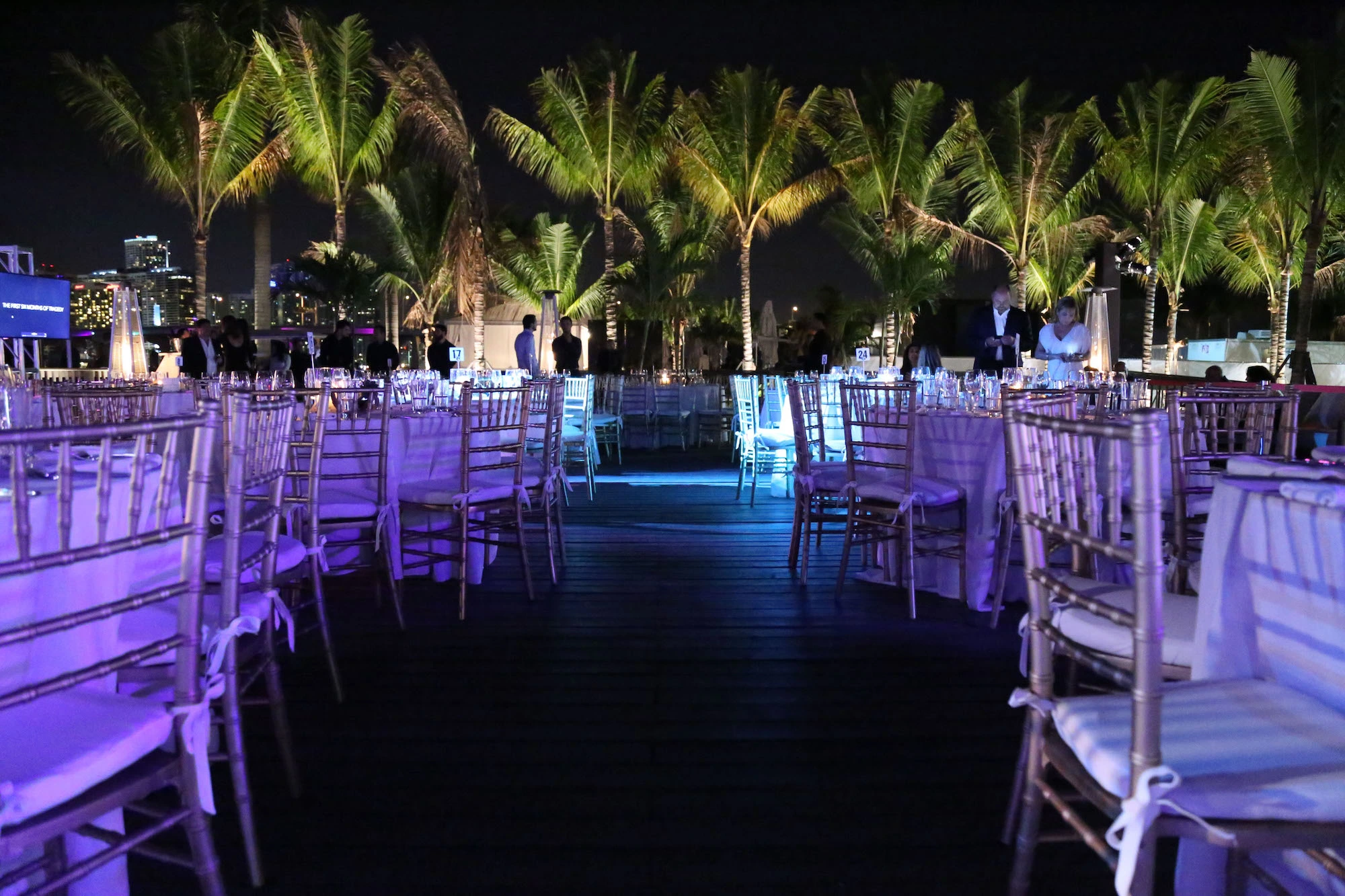 night photo of trees and tables for event space 